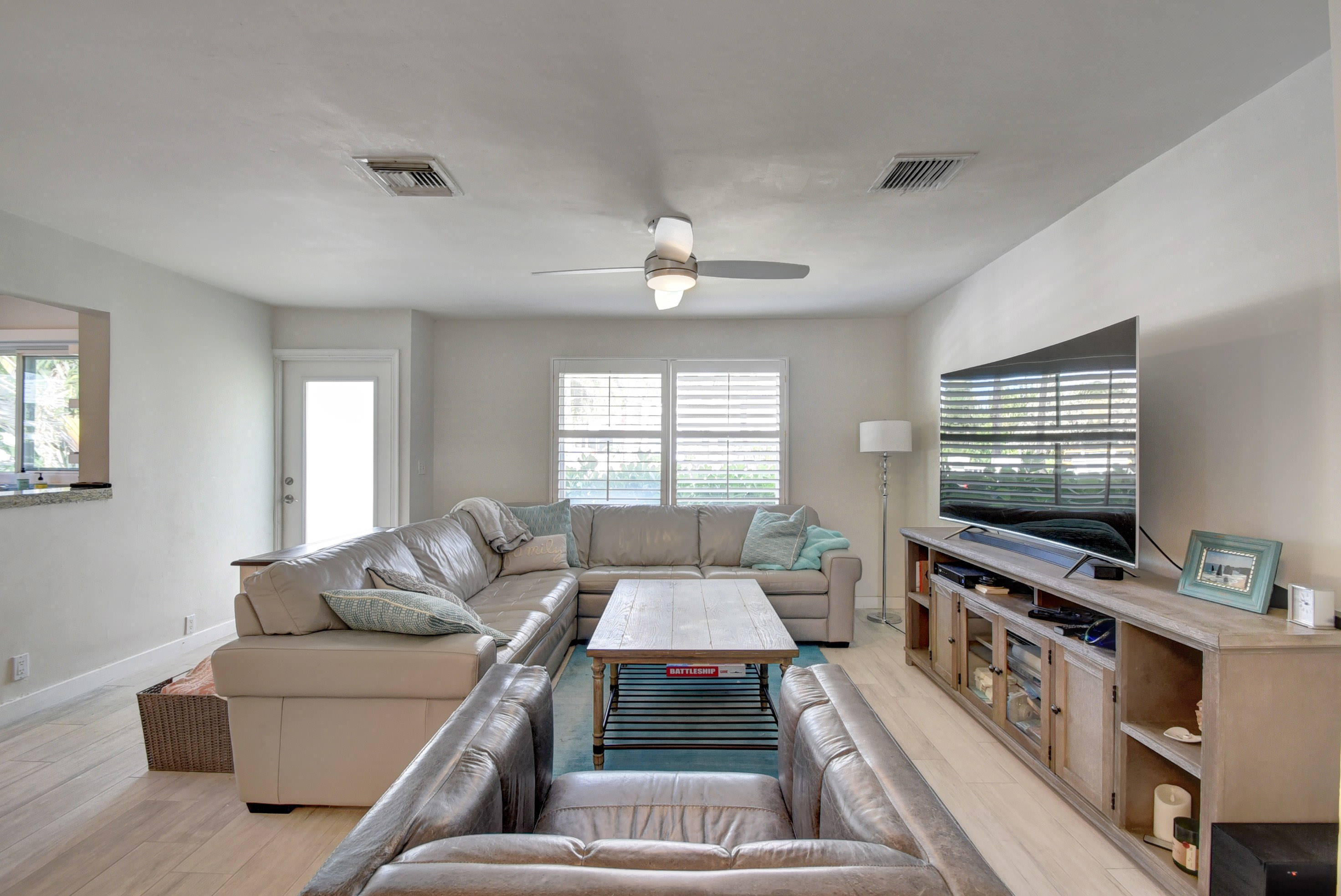 1020 Casuarina Road Delray Beach, FL 33483 - Photo 4 of 17 a living room with furniture and a flat screen tv