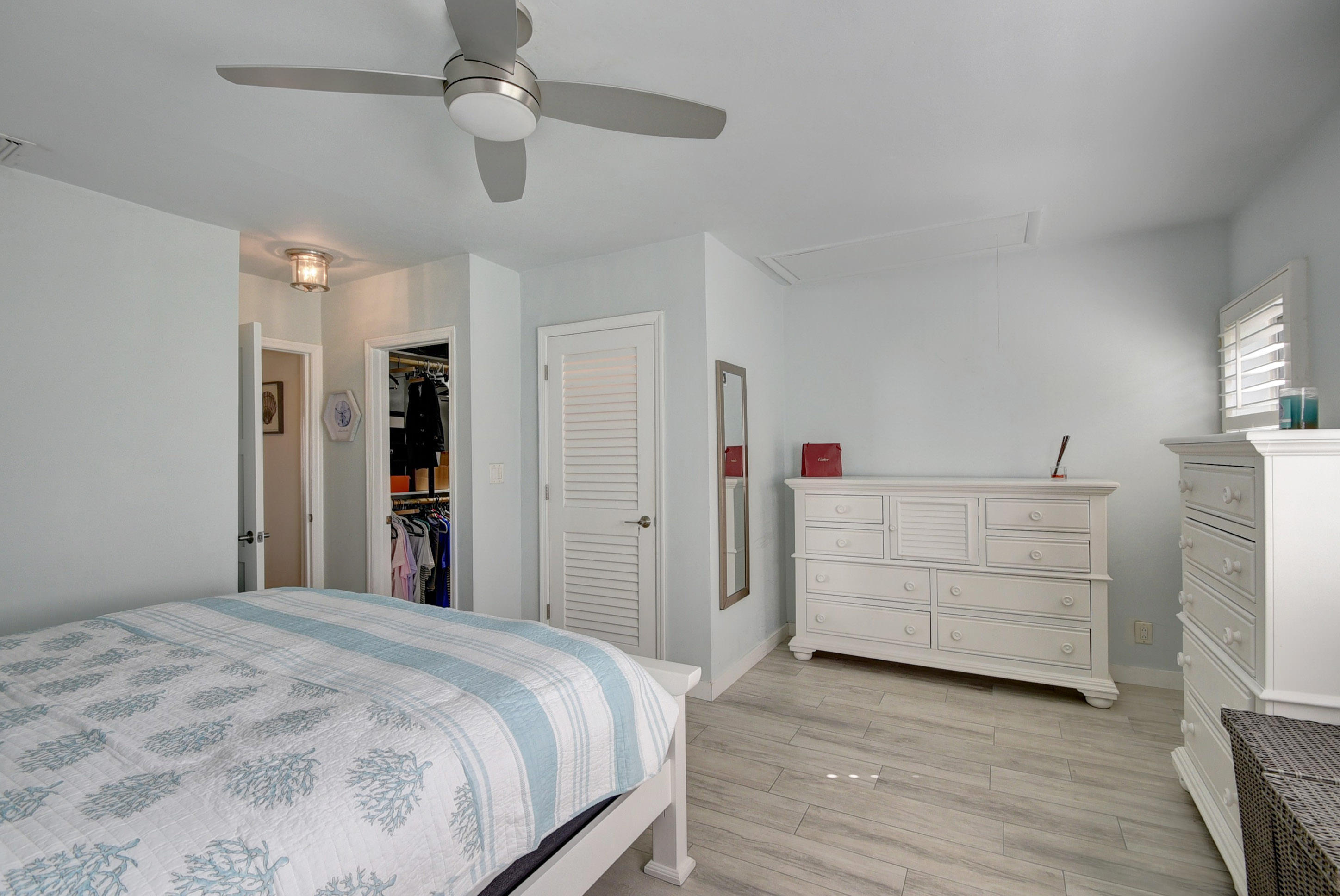 1020 Casuarina Road Delray Beach, FL 33483 - Photo 8 of 17 a bedroom with a bed and a dresser