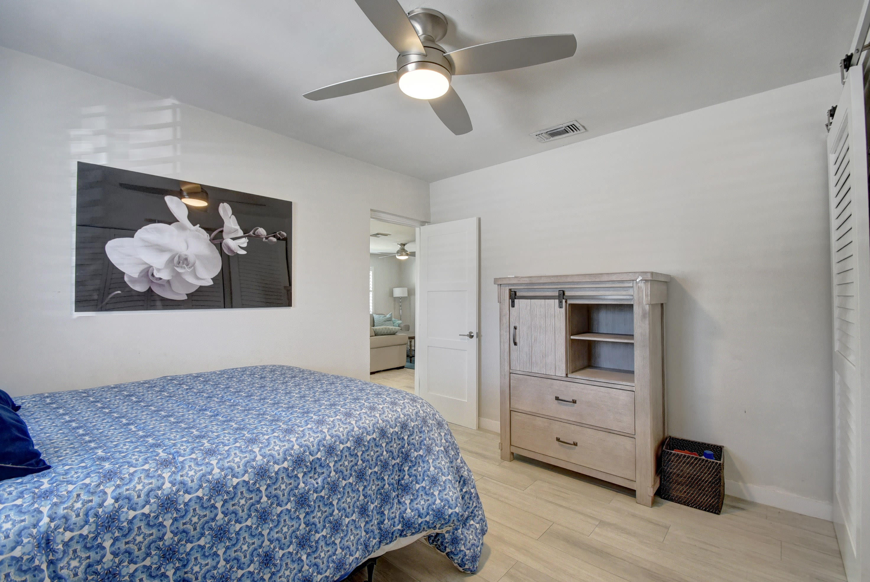 1020 Casuarina Road Delray Beach, FL 33483 - Photo 10 of 17 a bedroom with a bed and a chandelier