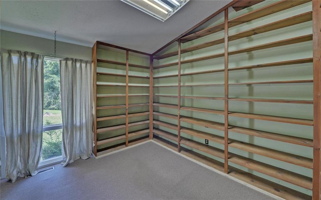 1858 Pinecrest Road Gainesville, GA 30501 - Photo 18 of 55 a view of walk in closet with empty racks