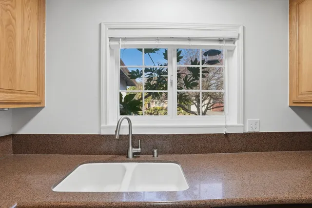 an empty room with windows and fireplace