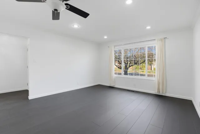 an empty room with a ceiling fan and a ceiling fan