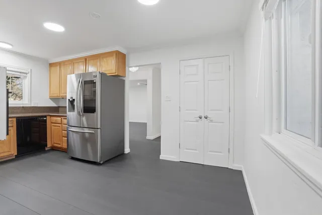 a kitchen with granite countertop cabinets stainless steel appliances and a sink