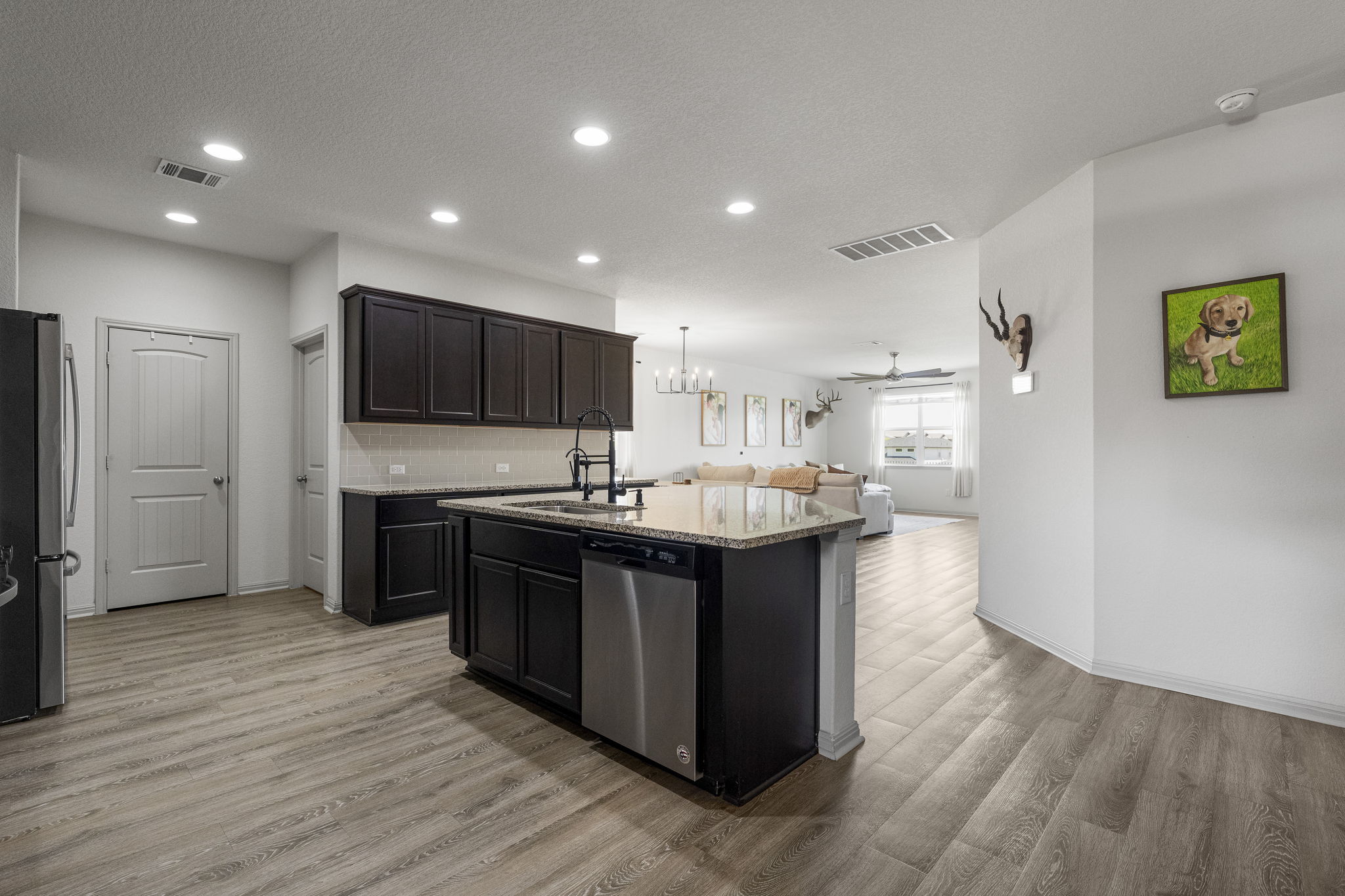 185 Struss Drive Georgetown, TX 78626 - Photo 3 of 23 The kitchen island offers ample counter space for meal prep and casual dining, creating a functional focal point.