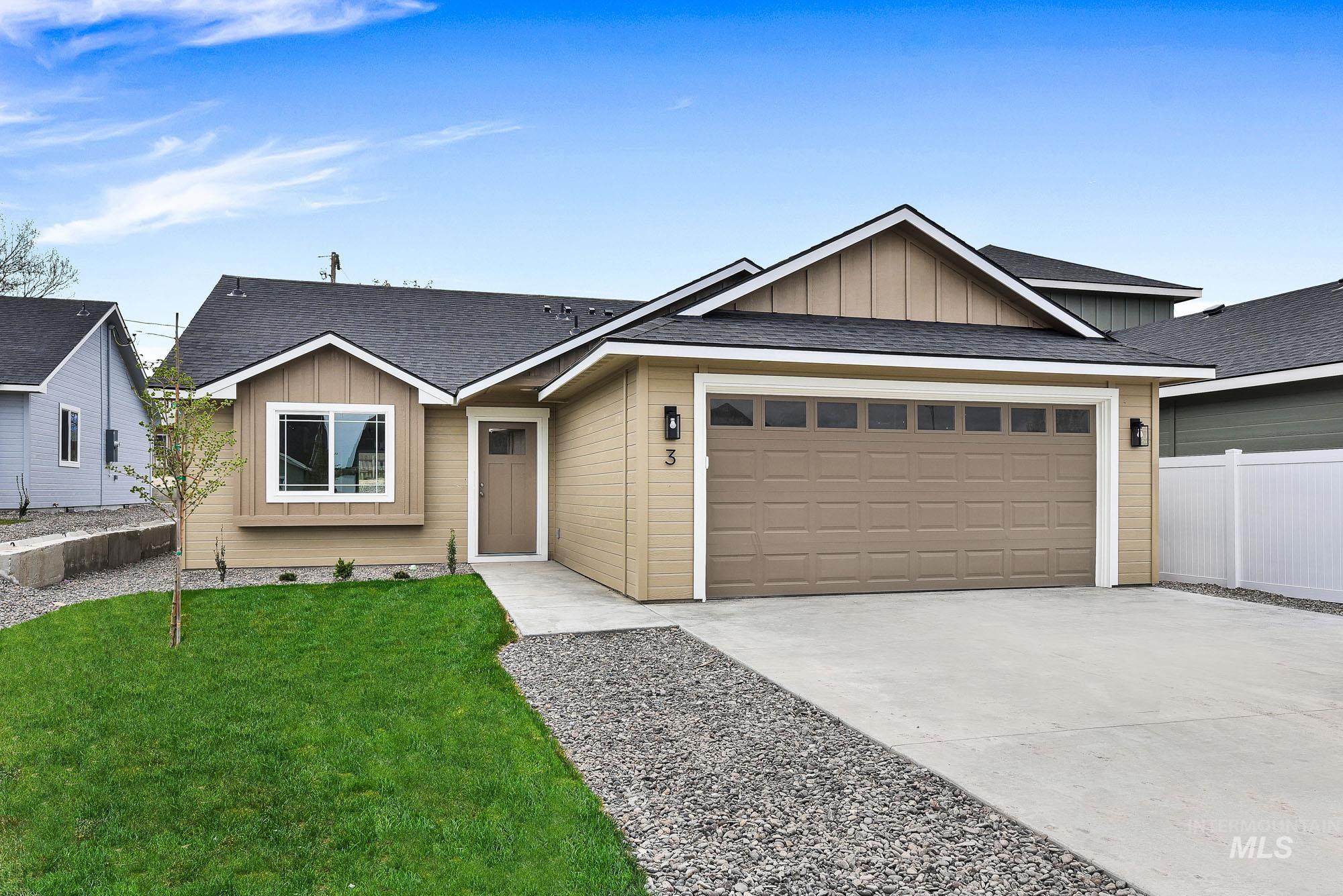 328 Packer Lane Homedale, ID 83628 - Photo 1 of 1 Ranch-style house featuring board and batten siding, roof with shingles, concrete driveway, and a garage