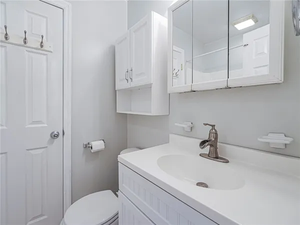 a bathroom with a sink a toilet and vanity