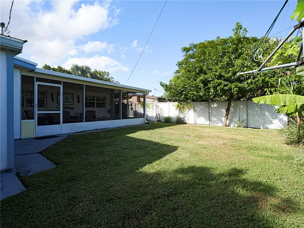 a view of house with backyard and porch