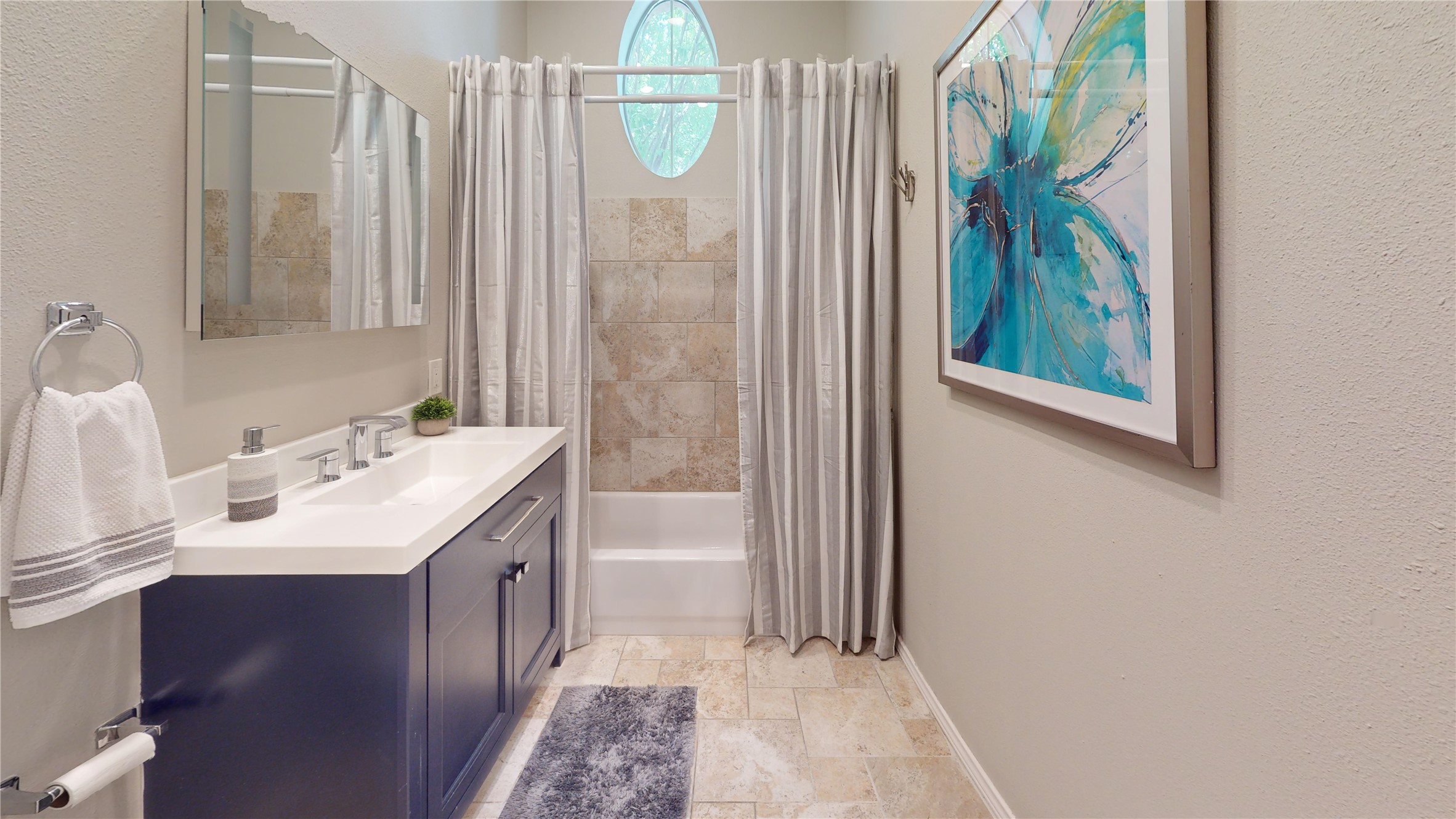 2918 Ranch Road 620, Unit 297 Austin, TX 78734 - Photo 6 of 37 Bathroom with stone tile flooring, vanity, shower / tub combo with curtain, and a textured wall