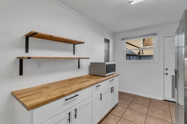 a hallway view with cabinets