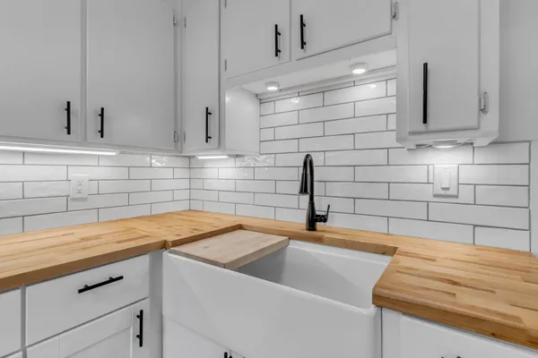 a kitchen with a sink and cabinets