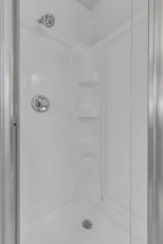 a bathroom with a glass shower door