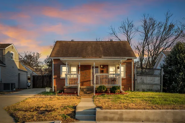 a backyard of a house with yard and outdoor seating