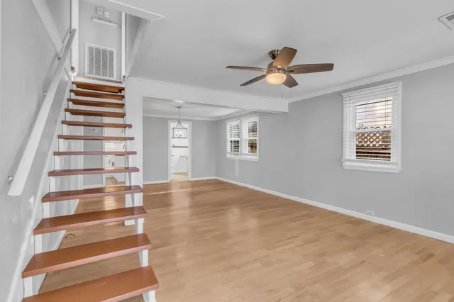 a view of an empty room with a window and stairs