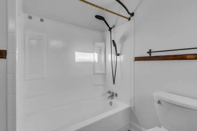 a bathroom with a bathtub and a shower