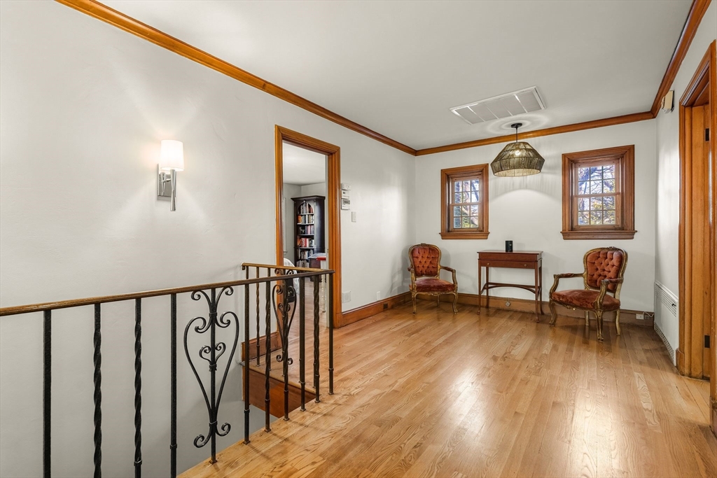 96 Gardner Road, Unit 96 Brookline, MA 02445 - Photo 21 of 42 a view of a hallway with wooden floor and furniture