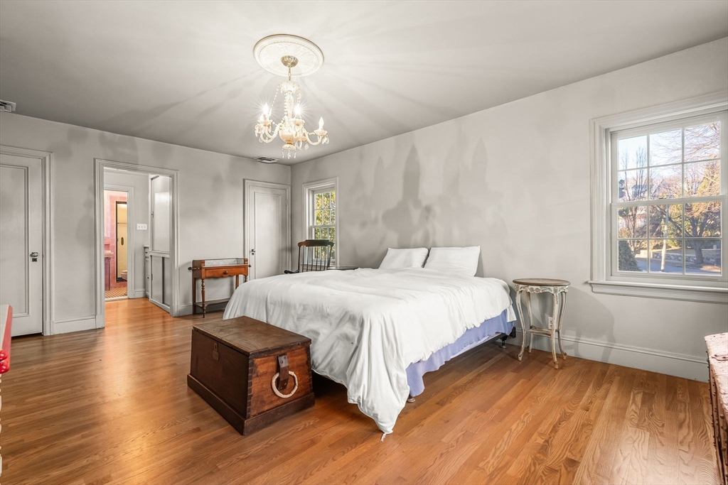 96 Gardner Road, Unit 96 Brookline, MA 02445 - Photo 24 of 42 a spacious bedroom with a bed and a wooden floor