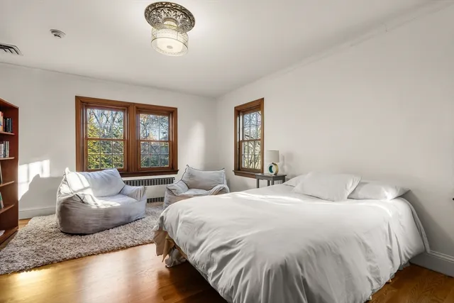 a spacious bedroom with two beds and a window