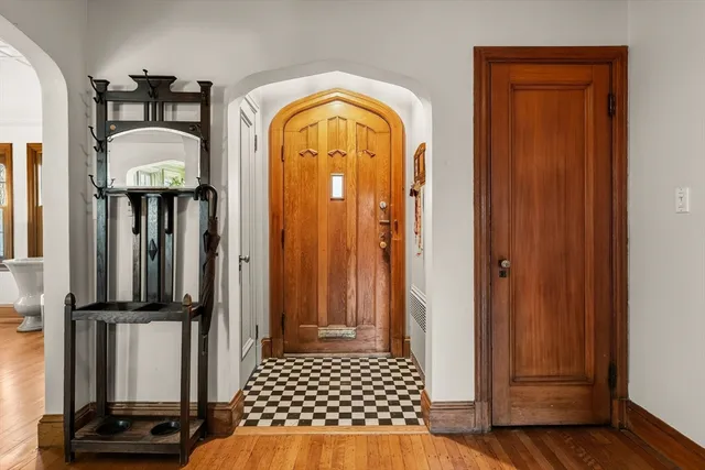 a view of a entryway door with wooden floor