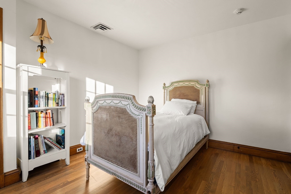 96 Gardner Road, Unit 96 Brookline, MA 02445 - Photo 32 of 42 a bedroom with bed and wooden floor