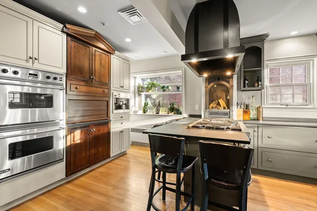 a kitchen with stainless steel appliances granite countertop a stove a sink and a refrigerator