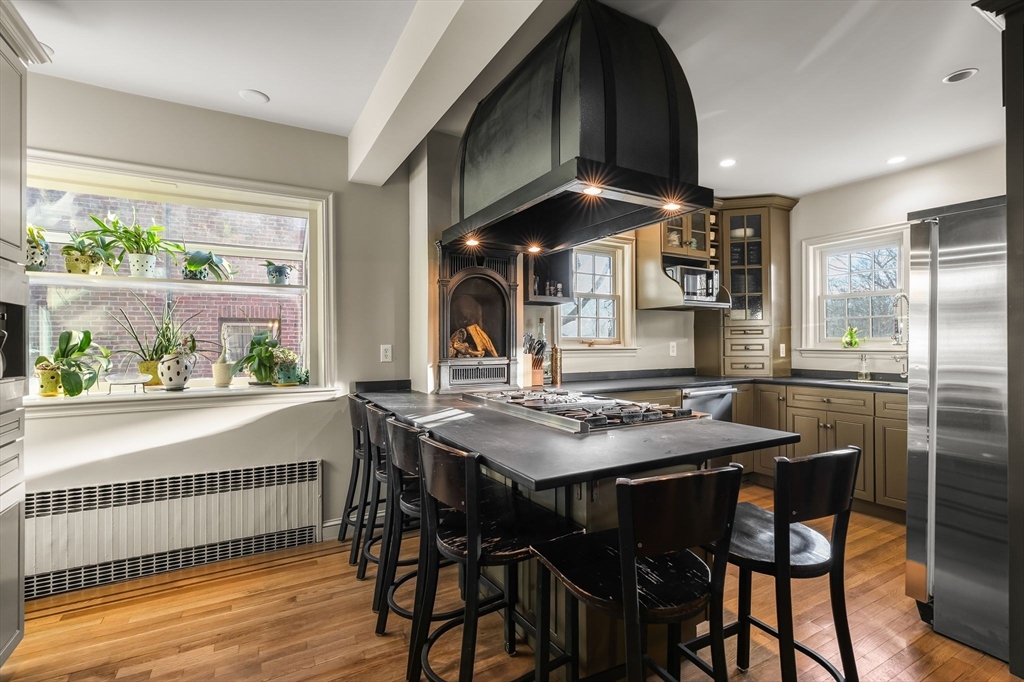 96 Gardner Road, Unit 96 Brookline, MA 02445 - Photo 9 of 42 a view of a dining room with furniture window and wooden floor