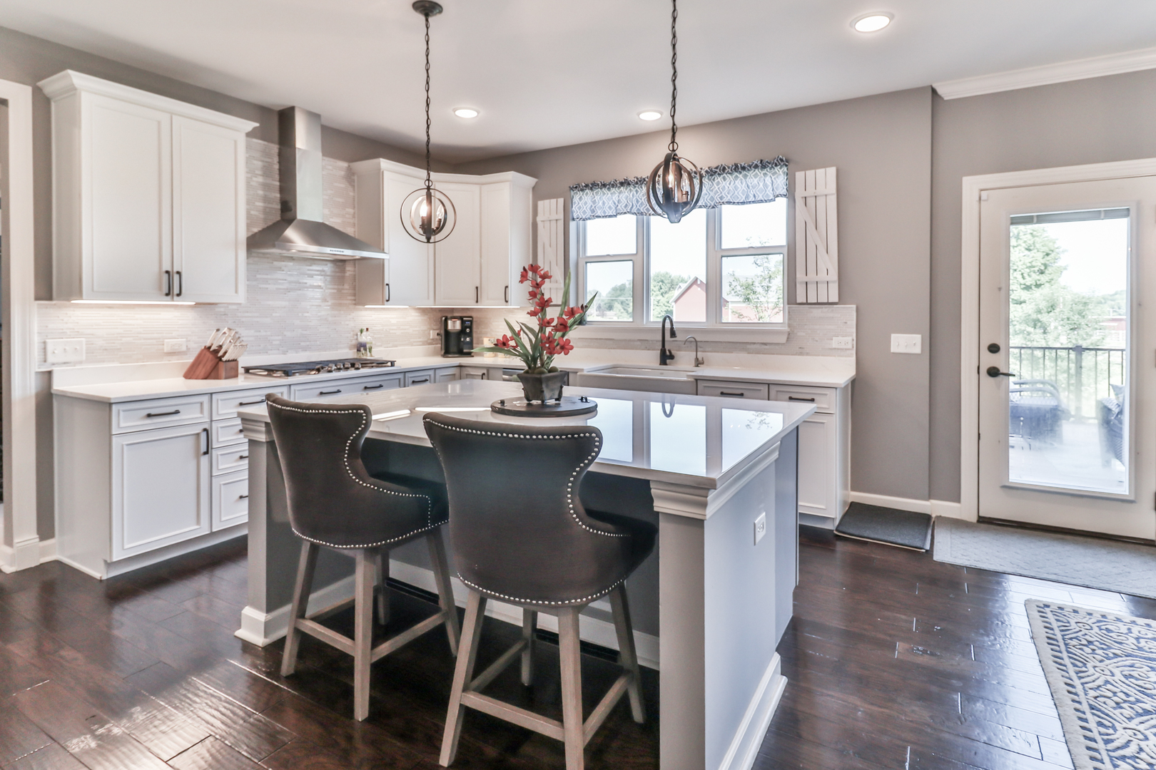 4392 Rudyard Kipling Road Elgin, IL 60124 - Photo 14 of 30 a kitchen with a dining table chairs sink and cabinets