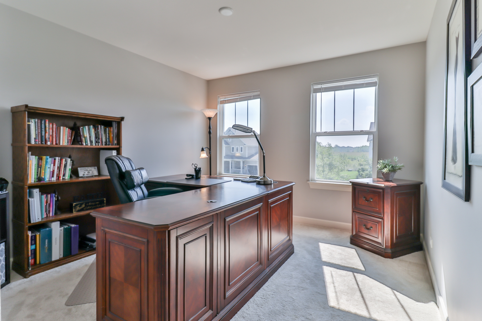 4392 Rudyard Kipling Road Elgin, IL 60124 - Photo 22 of 30 a view of a workspace with furniture and a book shelf