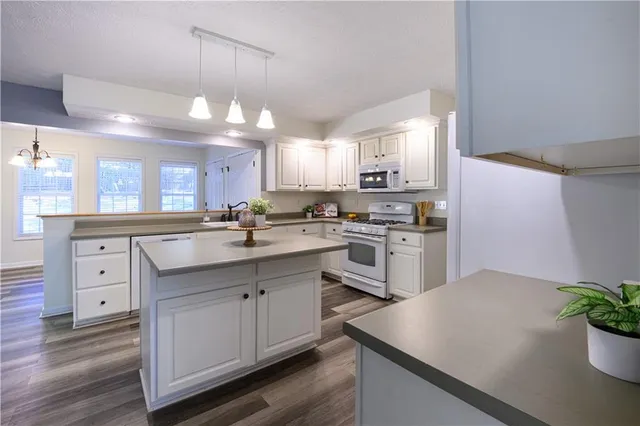 an empty room with a window and a ceiling fan