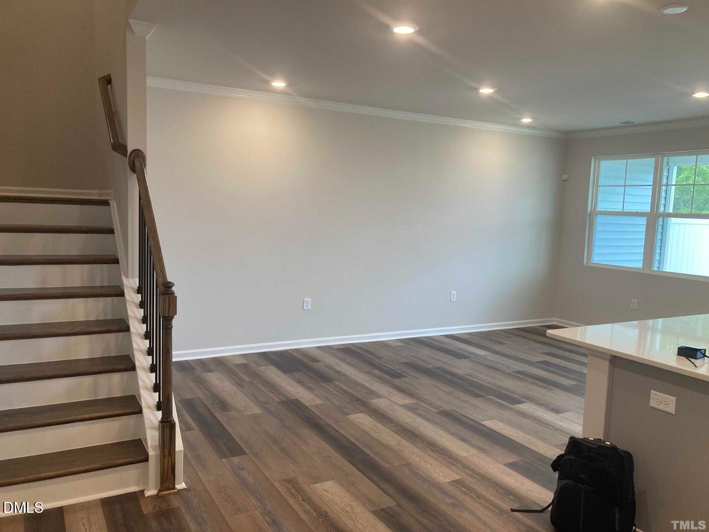1823 Caen Street Raleigh, NC 27610 - Photo 3 of 13 a view of entryway with stairs and wooden floor