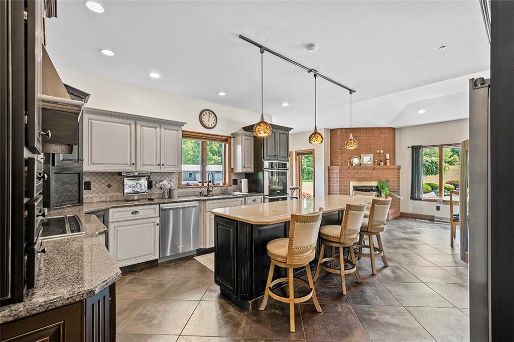 1860 Eastbrook Road New Castle, PA 16101 - Photo 13 of 25 a kitchen with sink cabinets and dining table