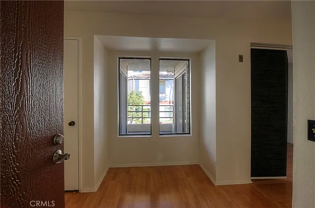 a view of a hallway with wooden floor and entryway