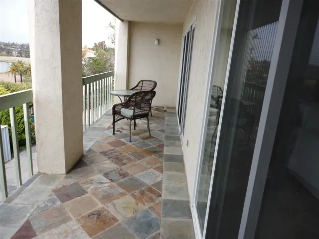 a view of a hallway with furniture and front door