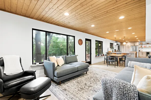 a dining room with furniture and a floor to ceiling window
