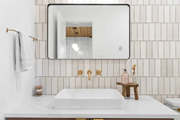 a bathroom with a sink toilet and mirror