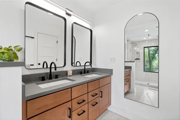 a bathroom with a sink a bathtub and a window
