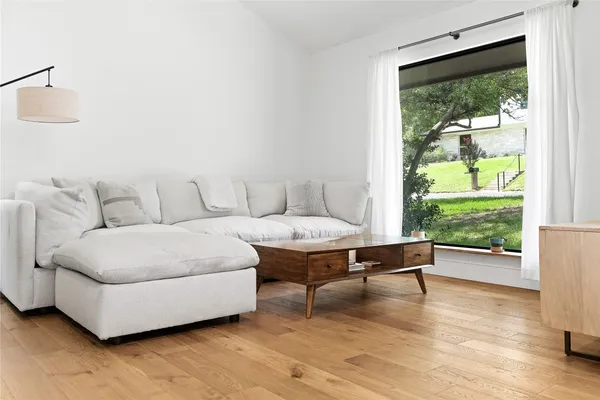 a living room with furniture and a wooden floor