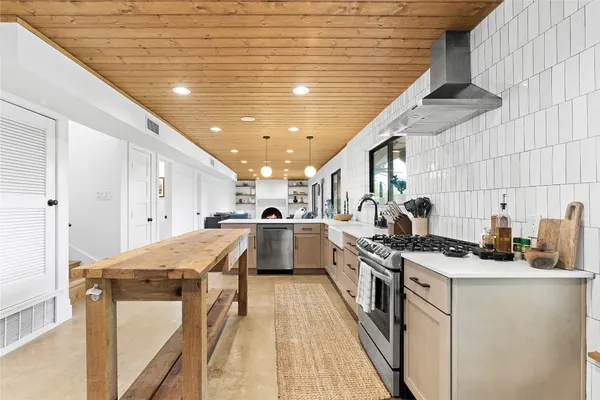 a kitchen that has a lot of cabinets in it