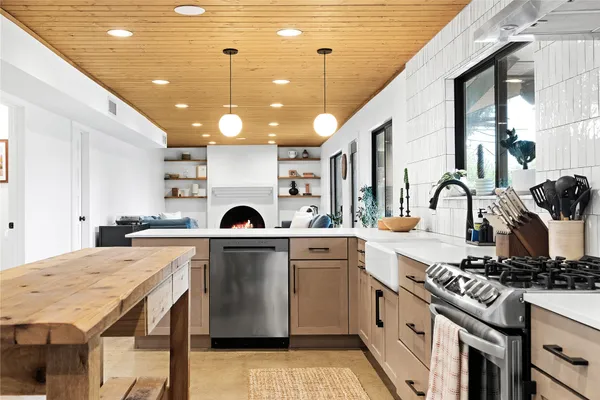 a large kitchen with a table and chairs
