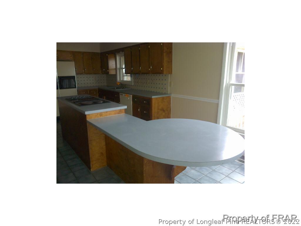 2121 Bainbridge Road Stedman, NC 28391 - Photo 7 of 16 a kitchen with a sink and cabinets