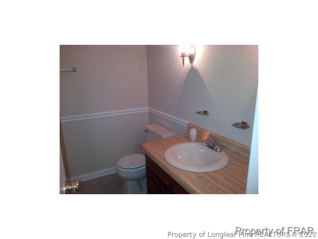 2121 Bainbridge Road Stedman, NC 28391 - Photo 8 of 16 a bathroom with a toilet a sink and mirror