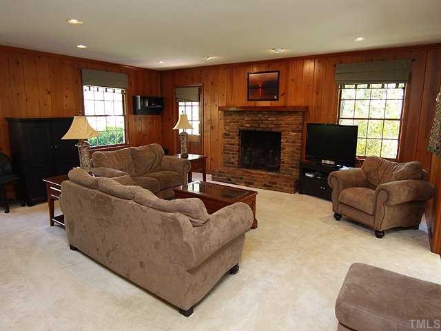 3722 Eton Road Durham, NC 27707 - Photo 13 of 25 Rich Tongue and Groove solid wood paneling frames the large Masonry Fireplace in the Family Room