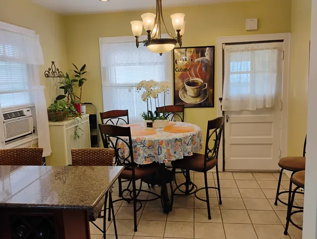 a view of a dining room with furniture and chandelier