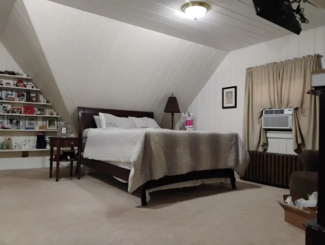 a bed sitting in a room next to a window