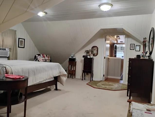 a bedroom with a bed and a mirror