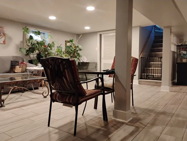 a view of a dining room with furniture and a potted plant