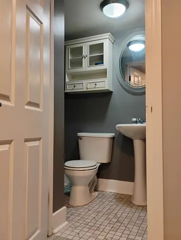 a bathroom with a toilet and a mirror