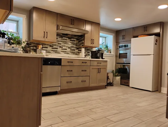 a kitchen with stainless steel appliances a refrigerator and cabinets