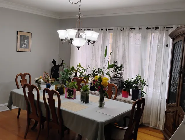 a view of a dining room with furniture and chandelier