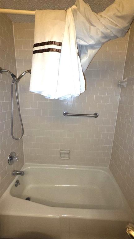 454 Cottage Circle, Unit 454 River Ranch, FL 33867 - Photo 20 of 27 a bathroom with a bath tub and a shower