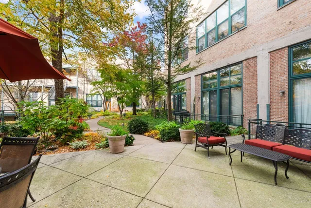 a view of a patio with chairs and potted plants